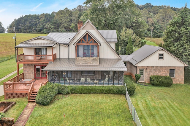 view of front of home with brick siding, a chimney, a pool, and a wooden deck