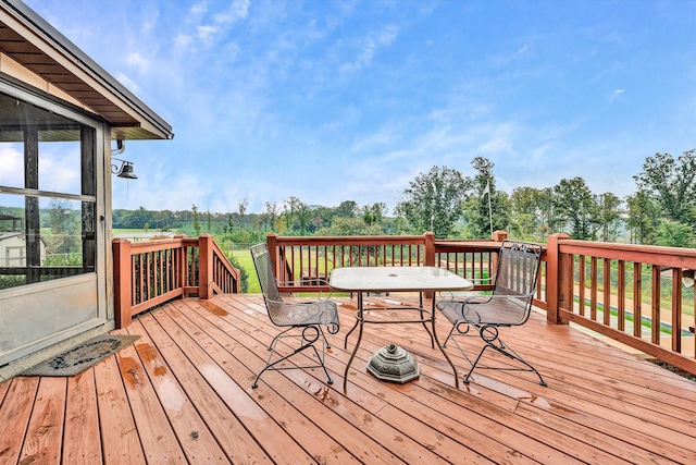 deck with outdoor dining area