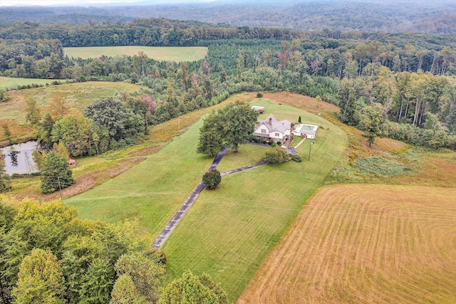 aerial view featuring a rural view and a wooded view