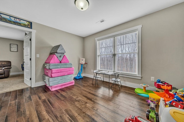 rec room featuring hardwood / wood-style flooring, visible vents, and baseboards