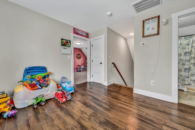 game room featuring wood finished floors, visible vents, and baseboards