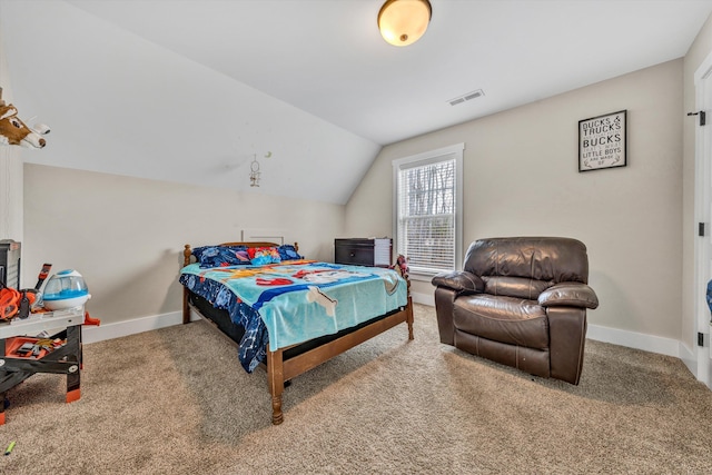 carpeted bedroom featuring lofted ceiling, baseboards, and visible vents