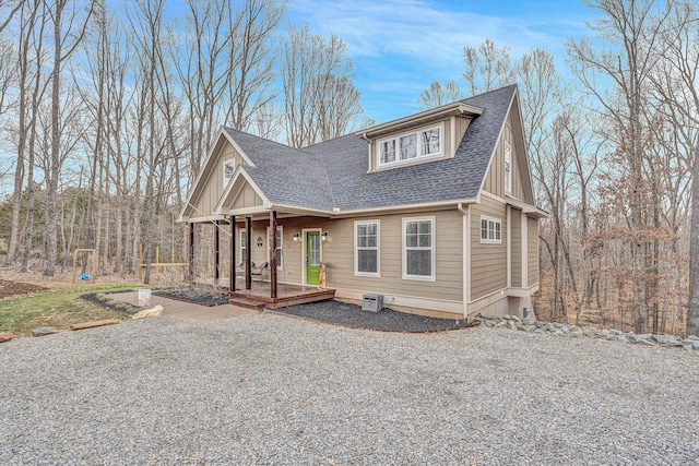 view of front of property with covered porch and roof with shingles