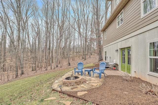 view of yard featuring an outdoor fire pit and a patio