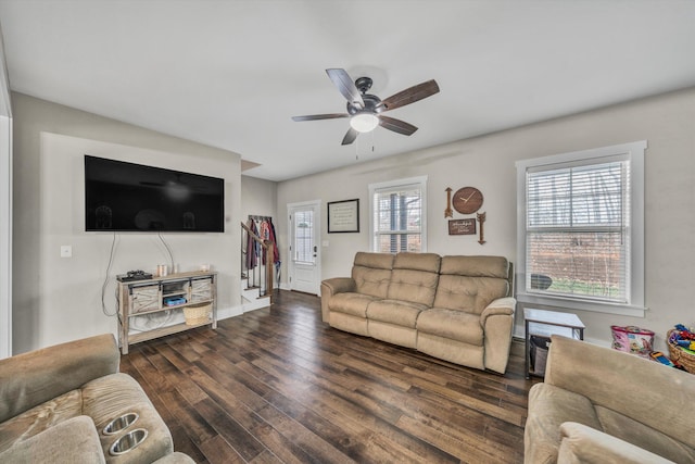 living room featuring dark wood-type flooring, ceiling fan, and baseboards