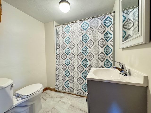 bathroom featuring toilet, a shower with shower curtain, and vanity