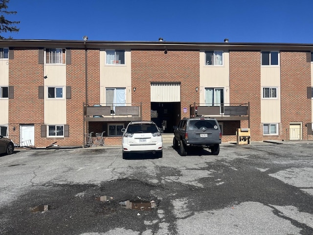 view of property with uncovered parking