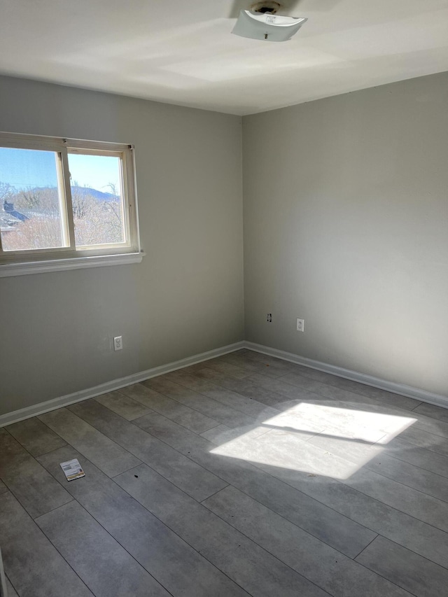 spare room with baseboards