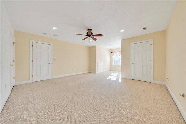 spare room featuring light carpet, baseboards, and visible vents