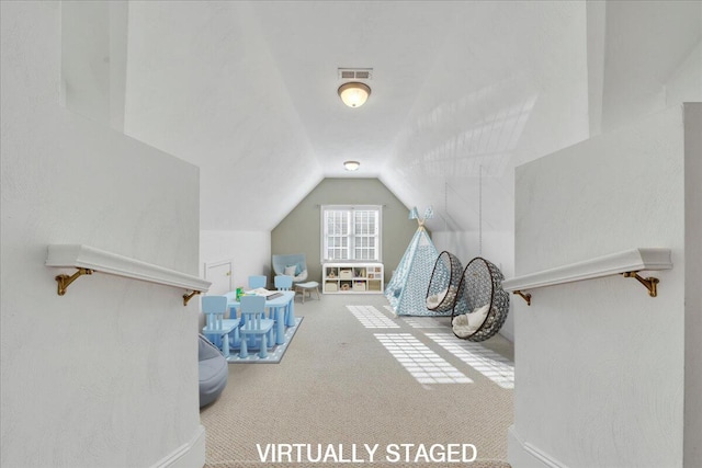 recreation room featuring carpet flooring, vaulted ceiling, and visible vents