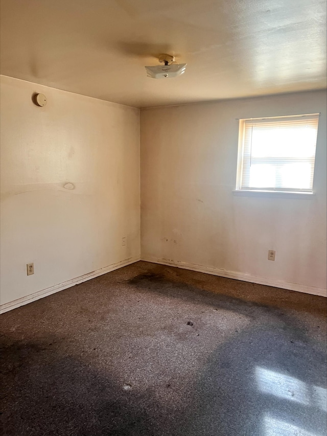 unfurnished room featuring baseboards