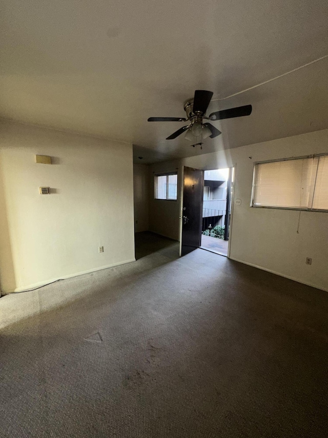 carpeted empty room with ceiling fan