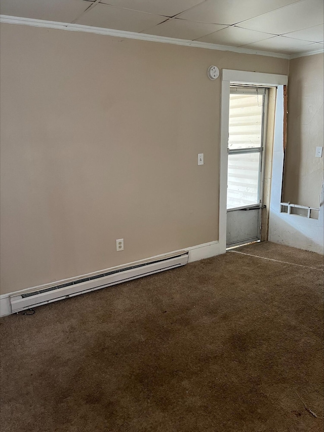 carpeted empty room with baseboard heating and crown molding