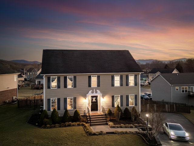 colonial home featuring fence and a mountain view