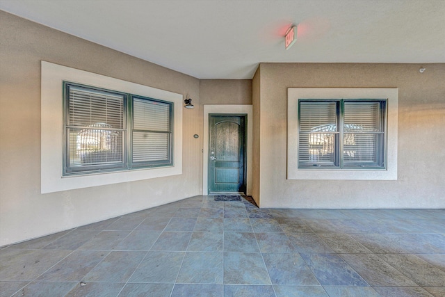 view of exterior entry with stucco siding