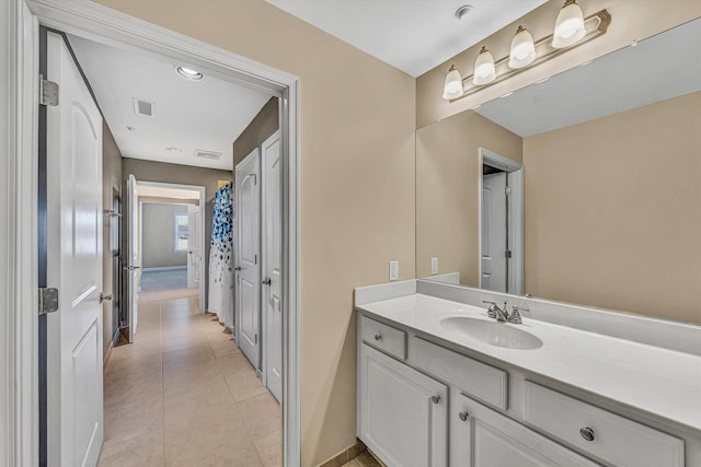 bathroom with vanity, visible vents, and tile patterned floors