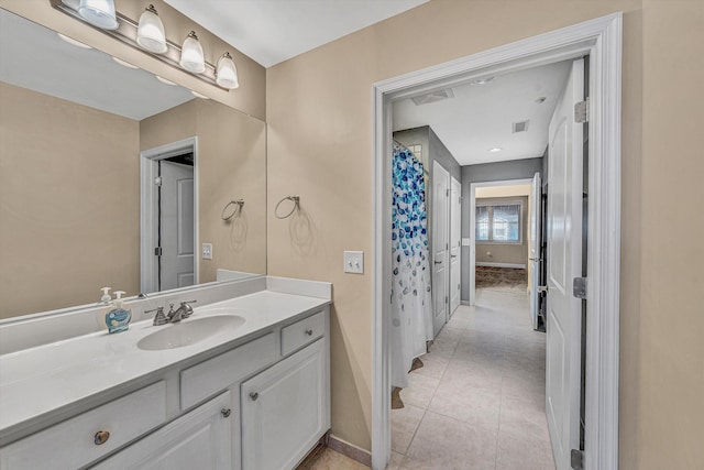 full bath featuring visible vents, tile patterned flooring, vanity, and baseboards