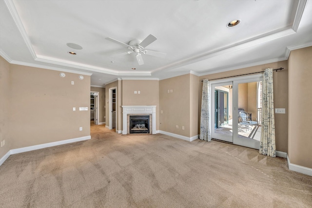 unfurnished living room featuring baseboards, a raised ceiling, a high end fireplace, and light colored carpet