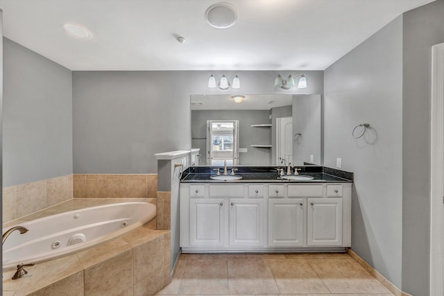 bathroom featuring double vanity, a jetted tub, a sink, and tile patterned floors