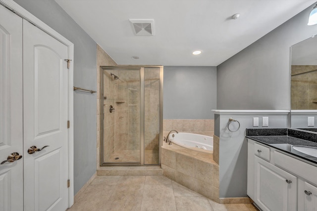 full bath featuring a stall shower, visible vents, a jetted tub, tile patterned flooring, and vanity