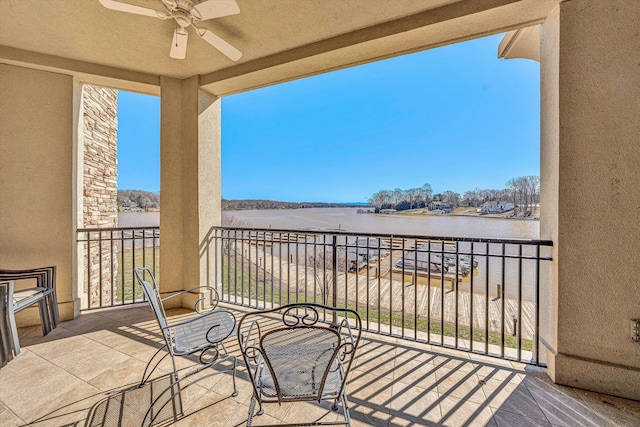 balcony with a water view and ceiling fan