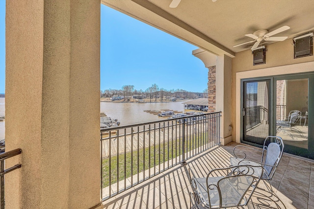 balcony featuring a water view and ceiling fan