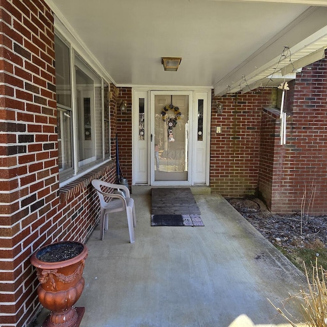 property entrance featuring brick siding