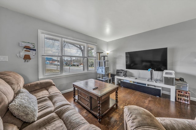 living area featuring baseboards and wood finished floors