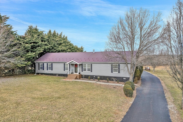 view of front of home with metal roof, driveway, crawl space, and a front yard