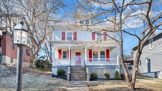 american foursquare style home featuring covered porch