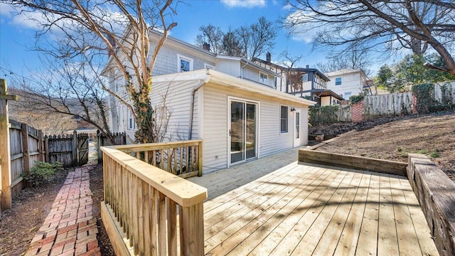 wooden terrace with a fenced backyard