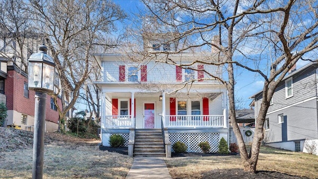 traditional style home featuring covered porch and brick siding