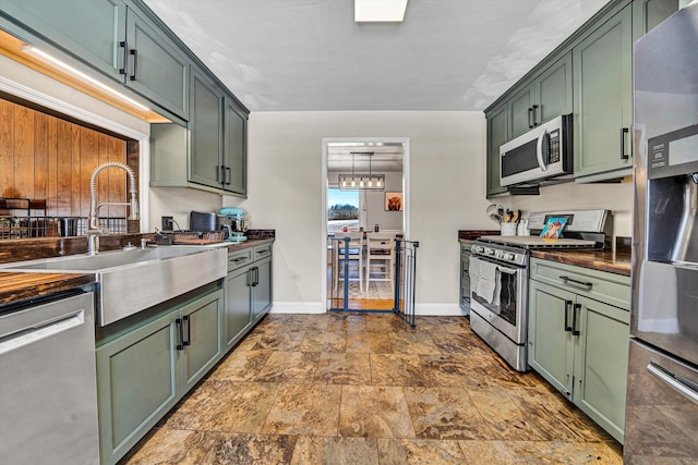 5359 Booker T Washington Hwy, Rocky Mount, VA 24151 - kitchen featuring green cabinets, stainless steel appliances, a sink, baseboards, and dark stone finish floors