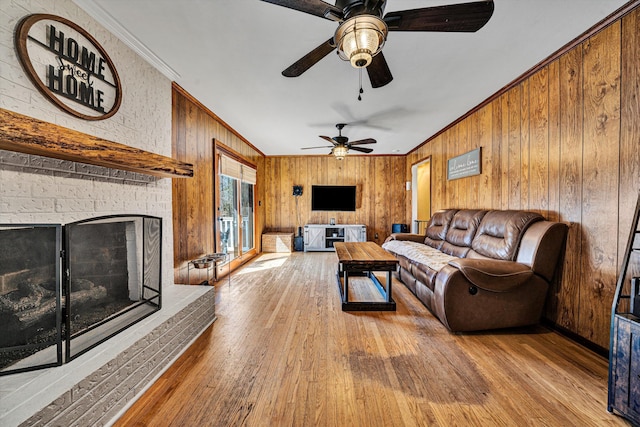 5359 Booker T Washington Hwy, Rocky Mount, VA 24151 - living room featuring a fireplace, crown molding, wood-type flooring, a ceiling fan, and wooden walls
