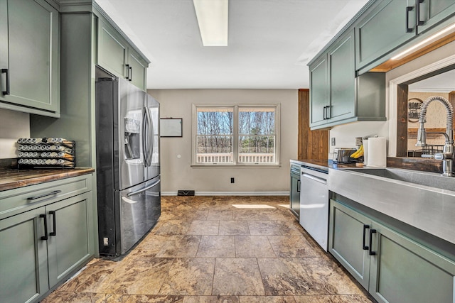 5359 Booker T Washington Hwy, Rocky Mount, VA 24151 - kitchen featuring green cabinetry, appliances with stainless steel finishes, dark countertops, and baseboards