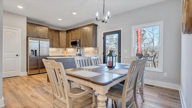 dining area with recessed lighting, a notable chandelier, visible vents, baseboards, and light wood-style floors