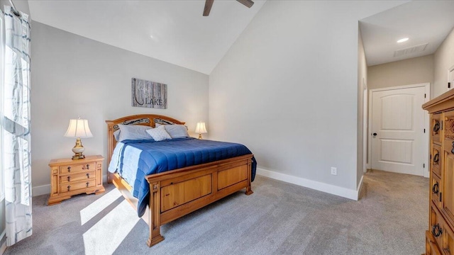 bedroom with lofted ceiling, visible vents, light carpet, and baseboards