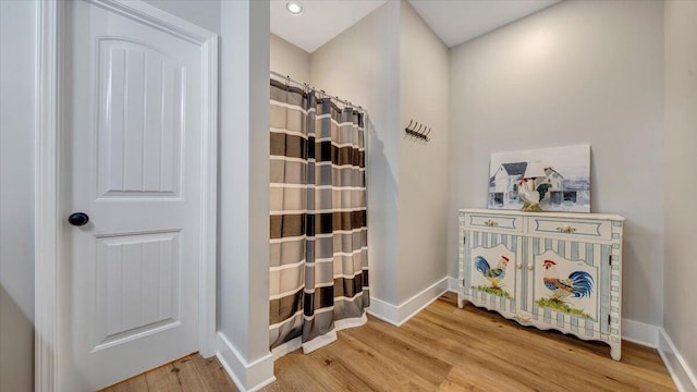 interior space with baseboards and wood finished floors