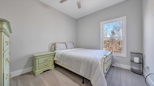 bedroom featuring baseboards, lofted ceiling, a ceiling fan, and light colored carpet