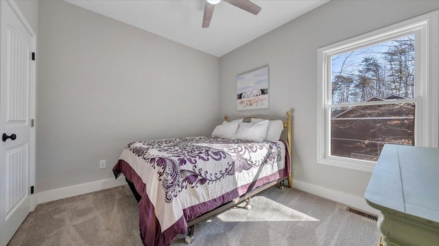 bedroom with lofted ceiling, visible vents, light carpet, ceiling fan, and baseboards