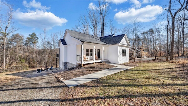 exterior space with a porch and a front lawn