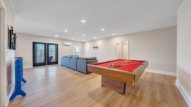 rec room with recessed lighting, french doors, light wood-style flooring, and a wall mounted AC