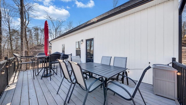 wooden terrace with outdoor dining space