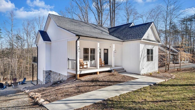 view of front of property featuring a porch and roof with shingles