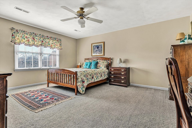 carpeted bedroom with visible vents, ceiling fan, and baseboards