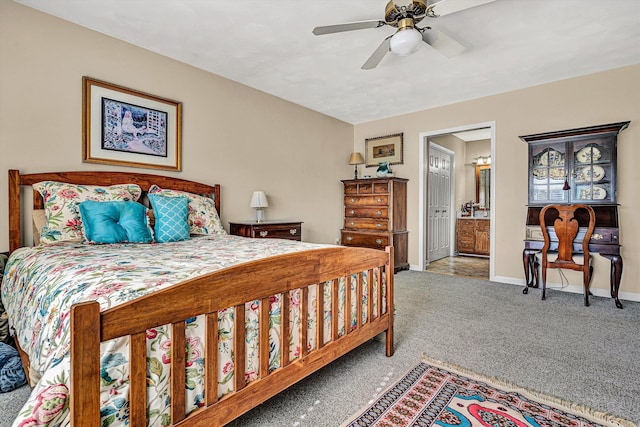 bedroom with a ceiling fan, carpet, connected bathroom, and baseboards