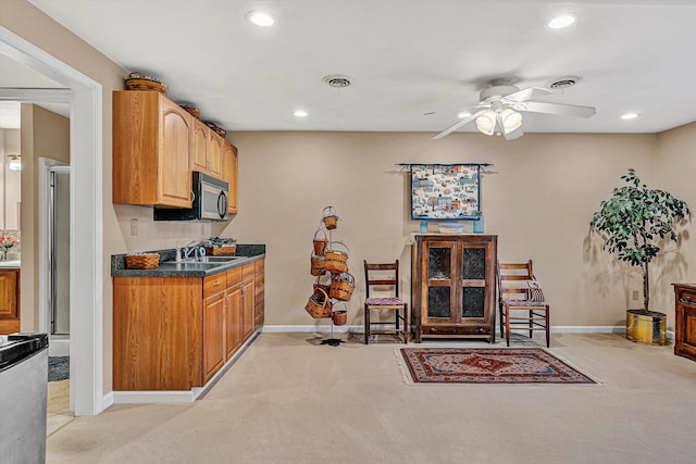 kitchen with baseboards, visible vents, a sink, and recessed lighting