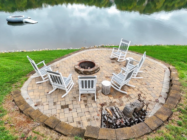 view of patio featuring a fire pit and a water view