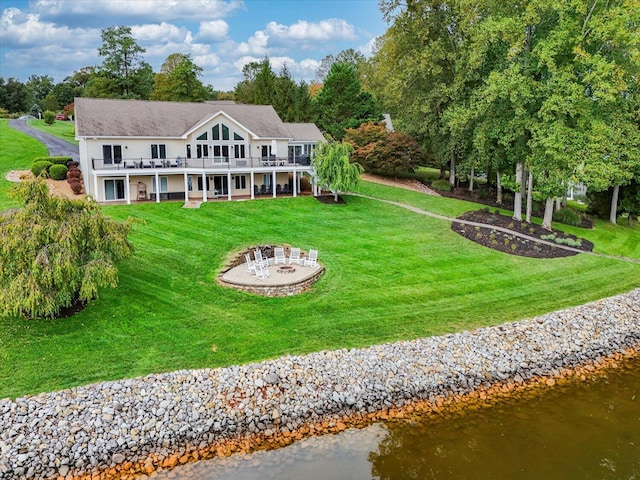 back of house featuring a yard and a deck with water view