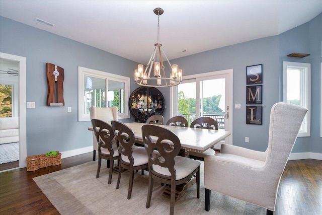 dining room with baseboards, visible vents, dark wood finished floors, and a notable chandelier